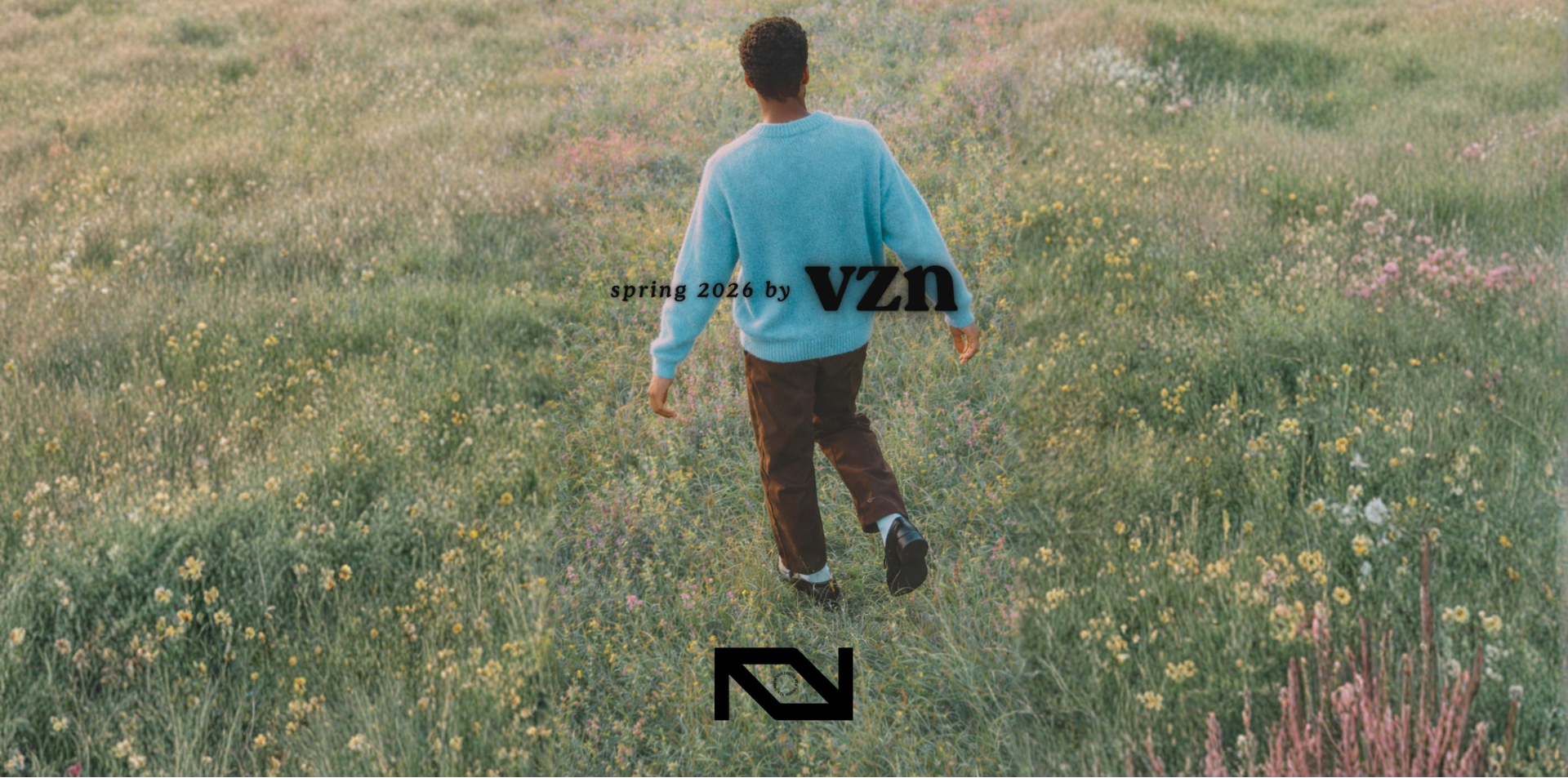 Person walking through a field with 'VZN' branding.